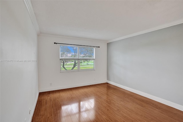 spare room with ornamental molding and hardwood / wood-style flooring