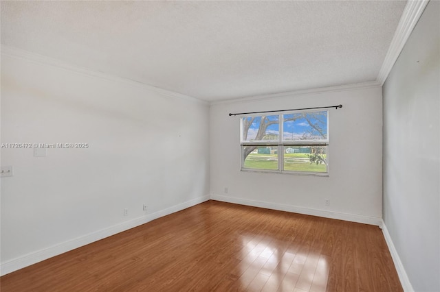 unfurnished room with ornamental molding, a textured ceiling, and wood-type flooring