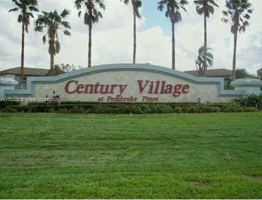 community sign featuring a yard