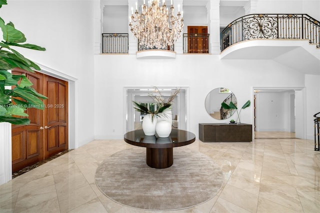 entrance foyer with a chandelier and a towering ceiling