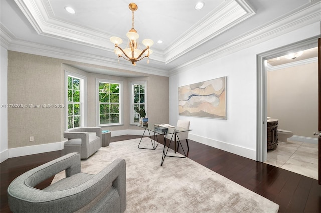 office with wood-type flooring, a notable chandelier, a tray ceiling, and ornamental molding