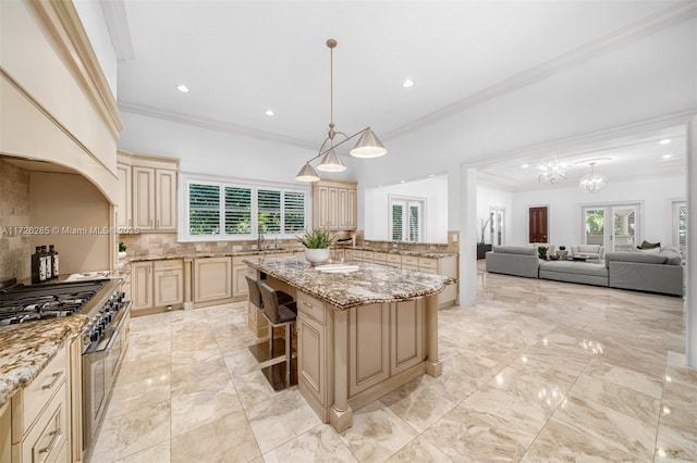 kitchen featuring decorative light fixtures, backsplash, a center island, high end stainless steel range oven, and light stone countertops