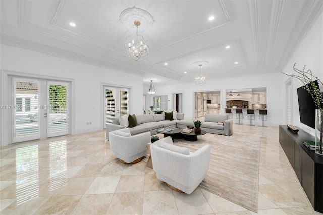 living room featuring an inviting chandelier, ornamental molding, a raised ceiling, and french doors