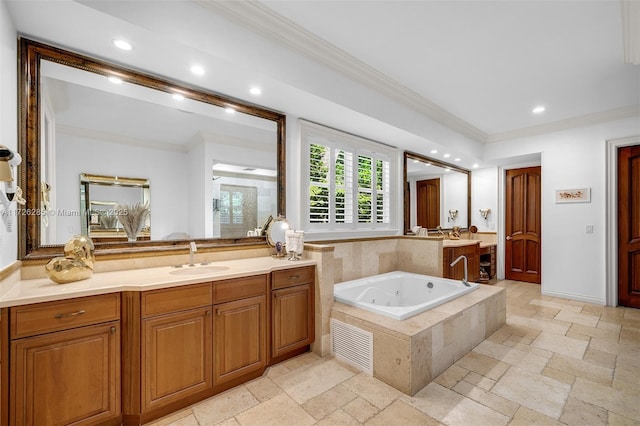 bathroom with tiled bath, vanity, and crown molding