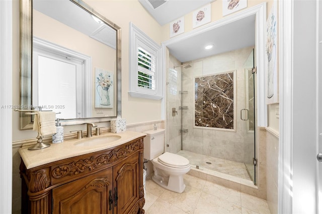 bathroom with toilet, a shower with shower door, and vanity