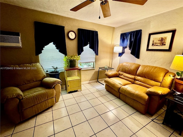 living room featuring a textured ceiling, ceiling fan, a wall mounted air conditioner, and light tile patterned floors