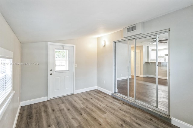 foyer featuring lofted ceiling and wood-type flooring