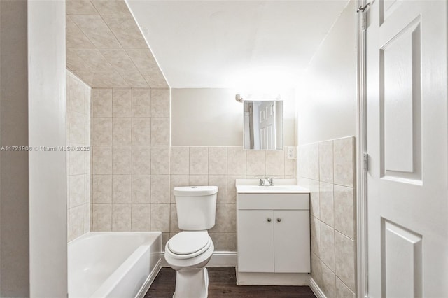 bathroom with tile walls, toilet, vanity, and hardwood / wood-style flooring