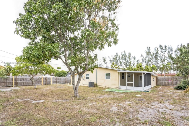 view of yard featuring cooling unit and a sunroom