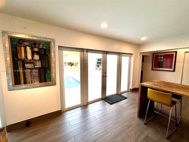 doorway with french doors and dark hardwood / wood-style floors