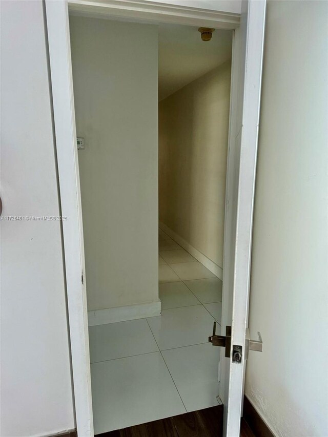 corridor with light tile patterned floors