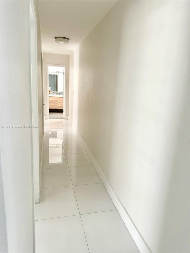 corridor featuring light tile patterned floors