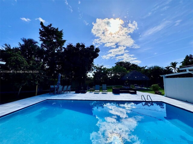 view of pool featuring a gazebo and a patio