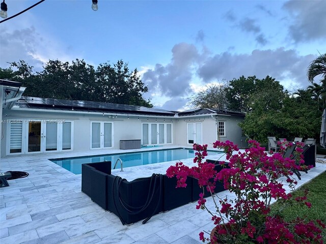 view of pool with a patio area and french doors