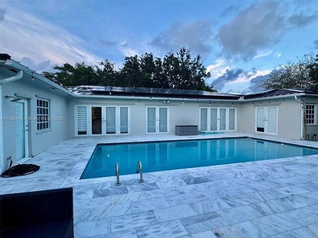 view of pool featuring french doors and a patio