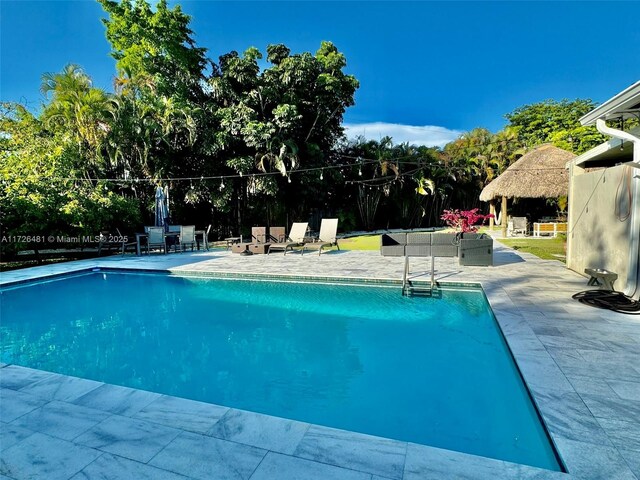 view of swimming pool featuring a patio area, a gazebo, and outdoor lounge area