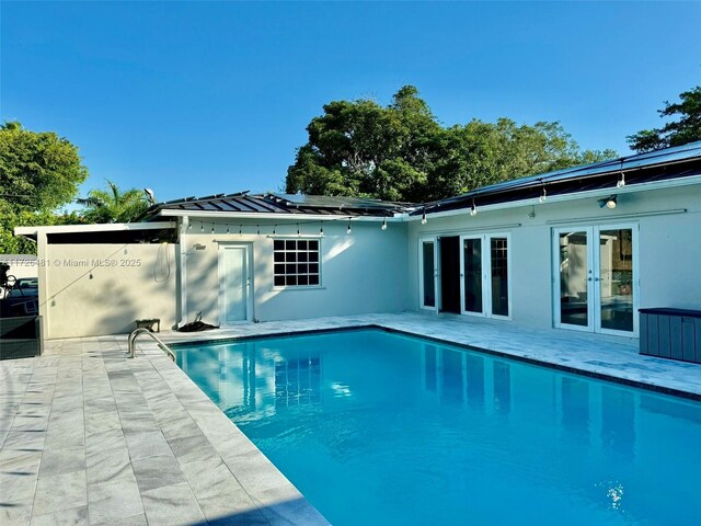 view of pool featuring french doors and a patio