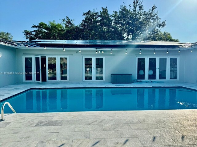 view of swimming pool featuring french doors