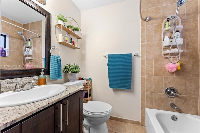 full bathroom featuring tiled shower / bath combo, tile patterned floors, vanity, and toilet