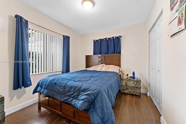 bedroom featuring dark wood-type flooring and a closet