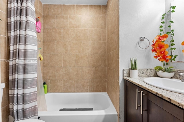 full bathroom featuring toilet, shower / bath combo with shower curtain, and vanity