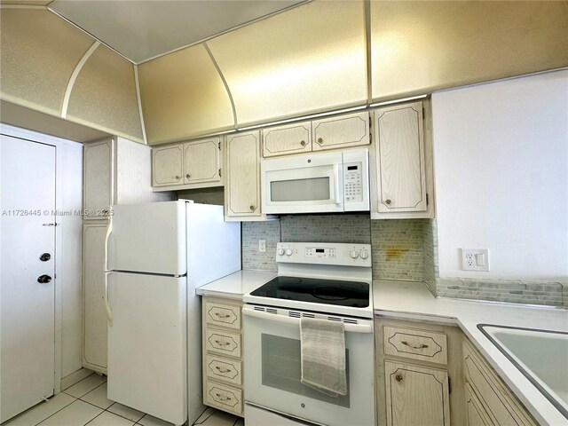 kitchen with sink, white appliances, decorative backsplash, and light tile patterned flooring