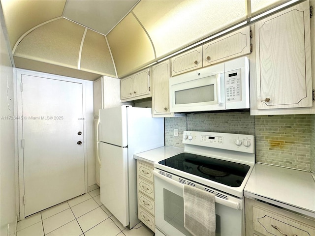 kitchen with white appliances, decorative backsplash, and light tile patterned floors