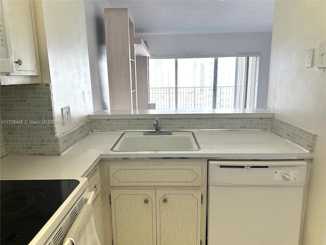 kitchen featuring sink, white appliances, decorative backsplash, and light brown cabinetry