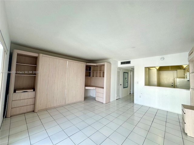 unfurnished living room with a textured ceiling