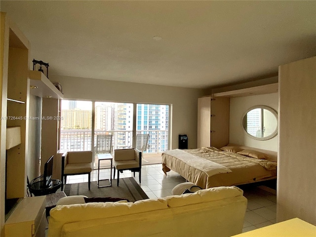 bedroom with light tile patterned flooring and access to exterior