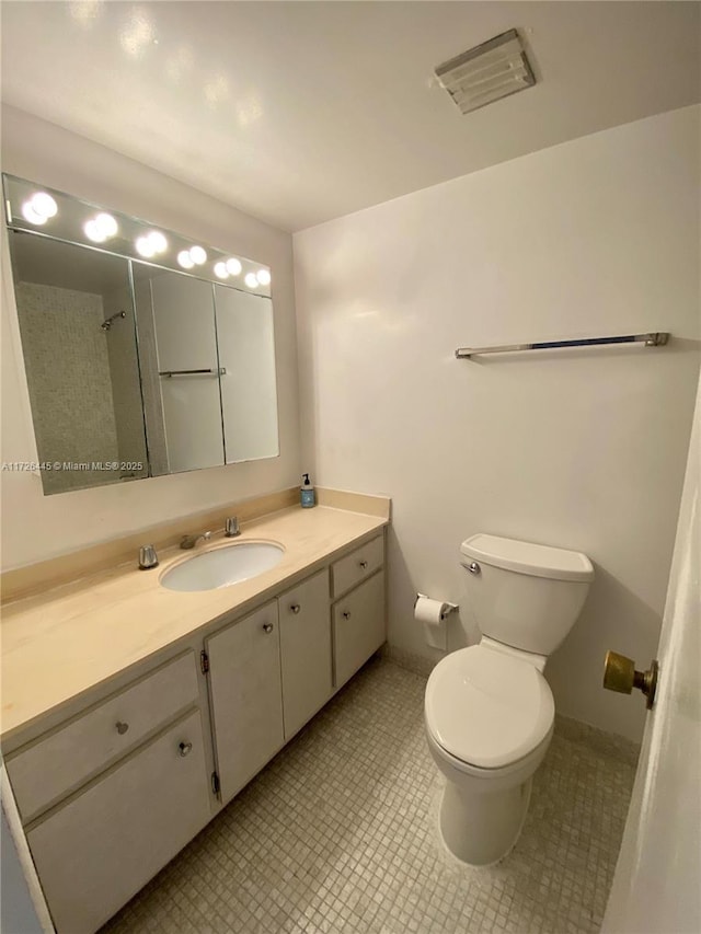 bathroom featuring toilet and vanity