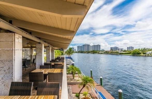 balcony with a boat dock and a water view