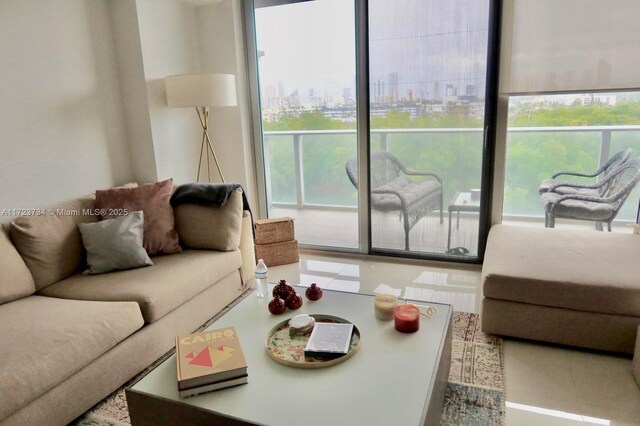 kitchen featuring oven, sink, stainless steel refrigerator, light tile patterned floors, and light brown cabinetry