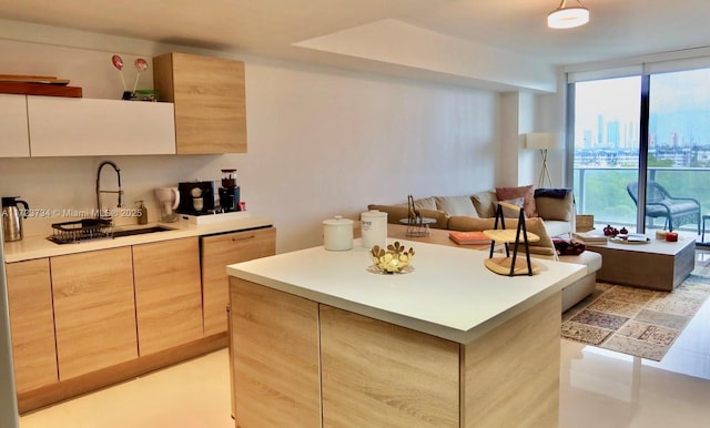 kitchen featuring a kitchen island, floor to ceiling windows, and sink