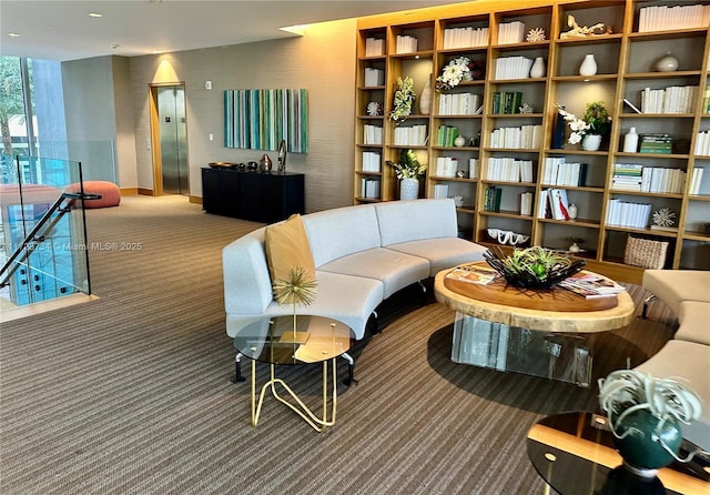 sitting room featuring carpet floors and elevator