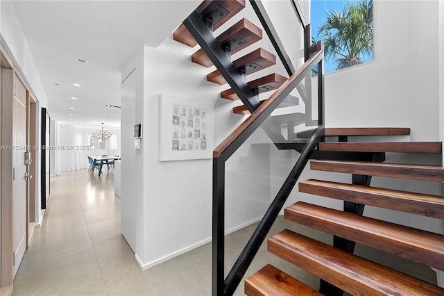 stairway with a chandelier