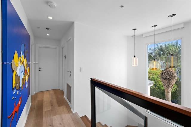 hallway with light hardwood / wood-style floors