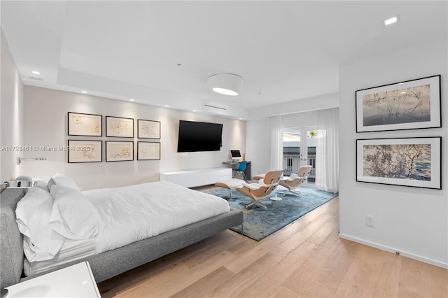 bedroom with light wood-type flooring and access to outside