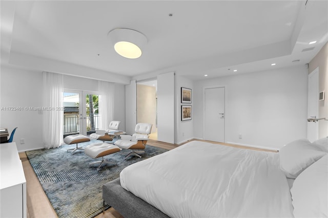 bedroom featuring light wood-type flooring and french doors