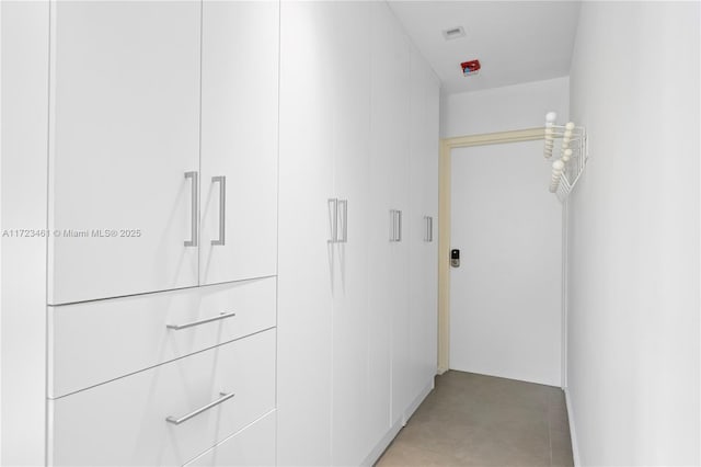 hallway featuring light tile patterned flooring