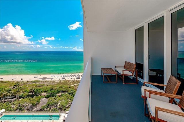 balcony with a beach view and a water view