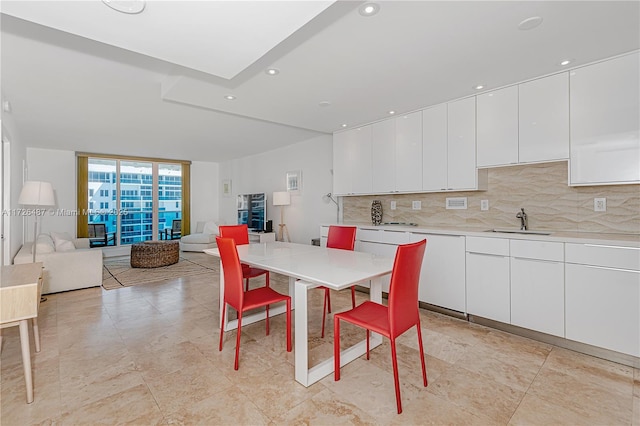 dining area featuring sink and expansive windows