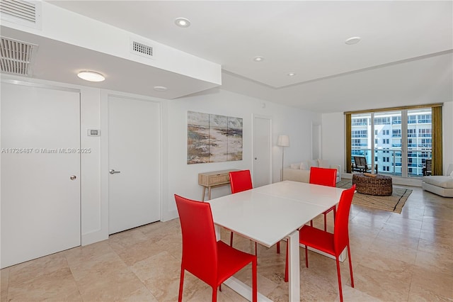 dining space with a wall of windows