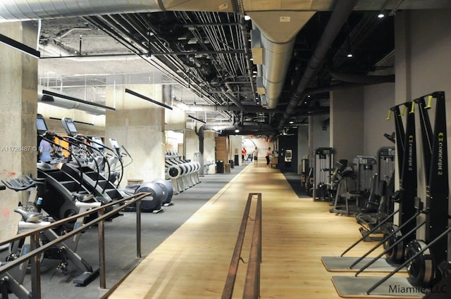 exercise room with wood-type flooring