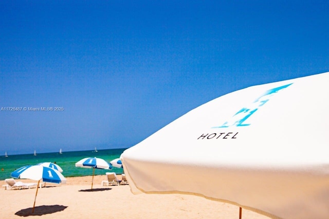 view of swimming pool with a water view