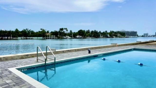 view of swimming pool featuring a water view