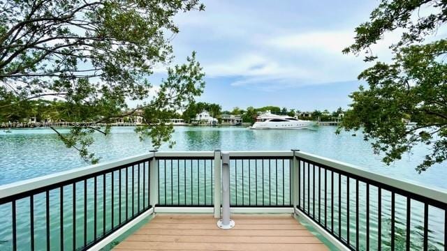 dock area featuring a balcony and a water view