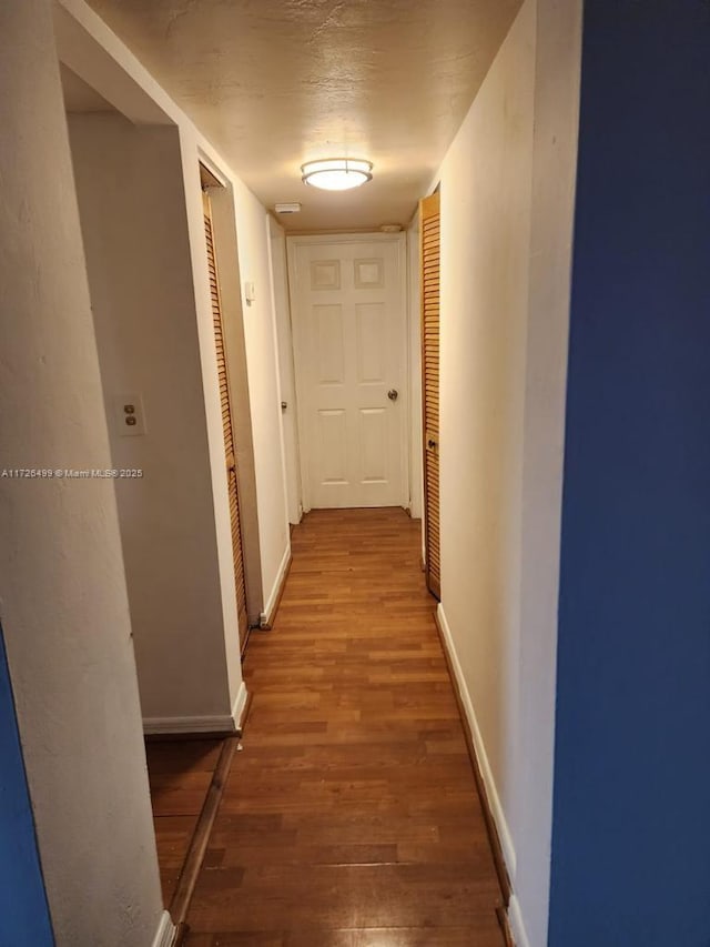 corridor featuring hardwood / wood-style flooring