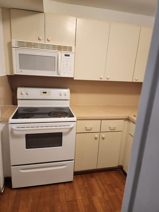 kitchen featuring wood-type flooring and white appliances