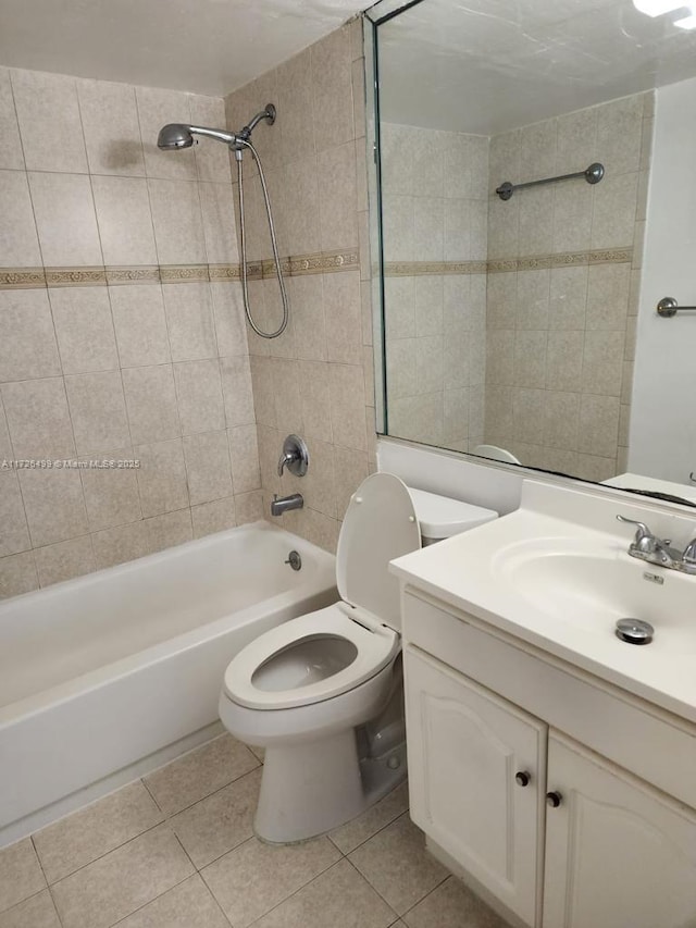 full bathroom with toilet, tiled shower / bath combo, tile patterned floors, and vanity